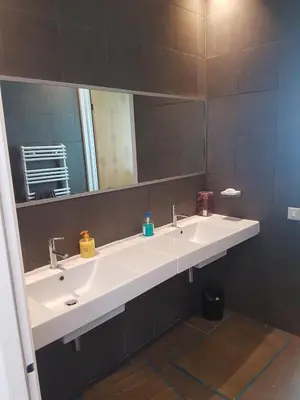 a bathroom with two sinks and a large mirror at Eden Island Villa - Bouznika in Bouznika