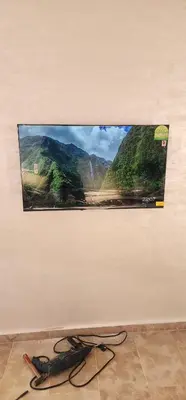 a flat screen tv hanging on a wall at Appartement Alaa in Mansouria