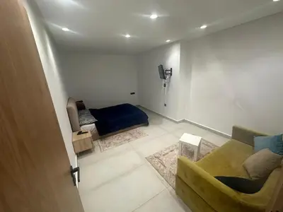 a small living room with a couch and a bed at زنقة توبقال أكدال عمارة 24 رقم 3 in Rabat