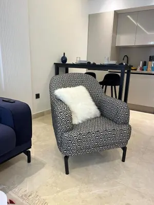 a chair with a white pillow in a living room at Cocon au coeur de Casablanca in Casablanca