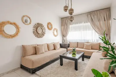 a living room with a couch and a table at Spacious 2Bedrooms Fully equipped-5min Agdal Station in Rabat