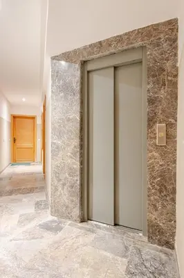 a door in a hallway with a stone wall at Modern 1 Bedroom W Terrace- Rabat City Center in Rabat