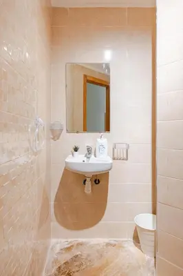 a bathroom with a sink and a mirror and a toilet at Modern 1 Bedroom W Terrace- Rabat City Center in Rabat