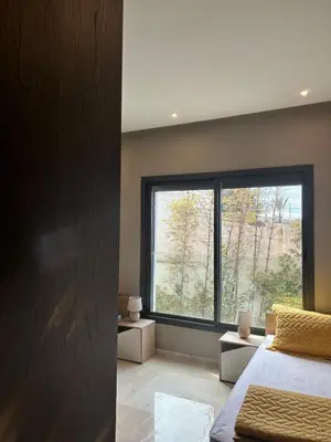a bedroom with a bed and a large window at شقة فخمه Luxury apartment in Casablanca