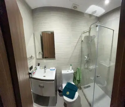 a bathroom with a shower and a toilet and a sink at Beautiful Apartment with Seaside Pool in Mansouria