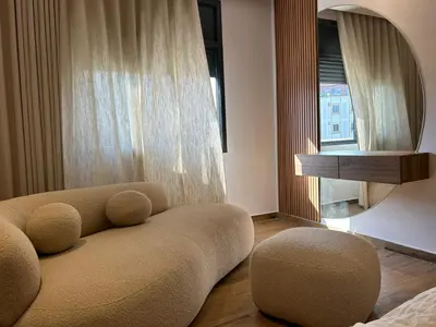 a living room with a couch and a mirror at Chahd appart centre de Rabat pour famille in Rabat