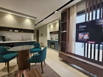 a living room with a tv and a table and chairs at Studio Seven Sky 1 - Close to CFC in Casablanca