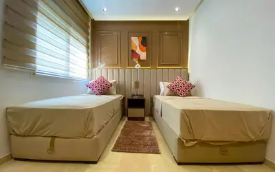 a bedroom with two beds and a window at Charming 2 Bedroom Casavoyageur in Casablanca
