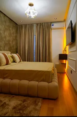 a bedroom with a bed with a couch in front of a window at Charming 2 Bedroom Casavoyageur in Casablanca