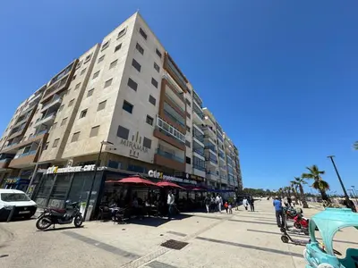 a tall building with people standing outside of it at Appartement Miramar vue panoramique Mohammedia in Mohammedia