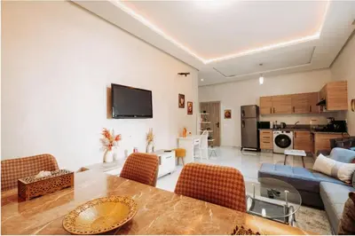 a living room with a table and a couch at Premium Romantic 1 Bedroom & Living Room with Swimming pool & Garden view in Casablanca