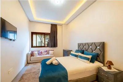 a bedroom with a large bed and a couch at Premium Romantic 1 Bedroom & Living Room with Swimming pool & Garden view in Casablanca