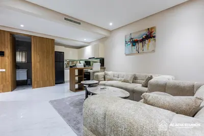 a living room with two couches and a kitchen at Acacia Studio 10 in Casablanca