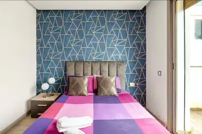 a bedroom with a large bed with a colorful blanket at Sunshine sea view studio in Casablanca