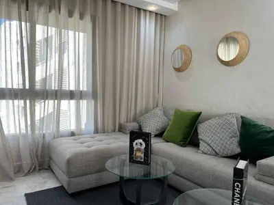 a living room with a couch and a table at Appartement luxueux au bord du mer in Casablanca