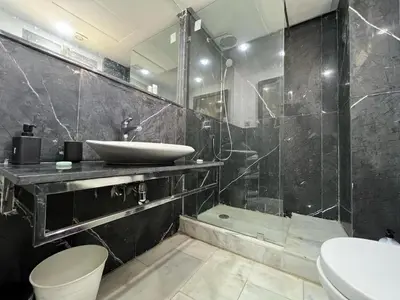 a bathroom with a sink and a toilet and a shower at Appartement luxueux au bord du mer in Casablanca
