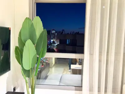 a window with a view of a city at night at Parking - Stunning View - Modern cozy and central in Casablanca