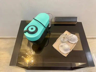 a blue object on a glass table with plates on it at Ultimate ocean luxury in Tamaris