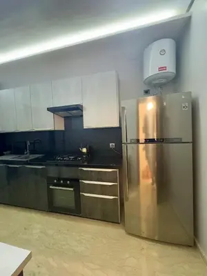 a kitchen with a stainless steel refrigerator and a stove at Ultimate ocean luxury in Tamaris