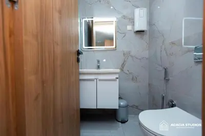 a bathroom with a sink and a toilet and a mirror at Acacia Studio 02 in Casablanca