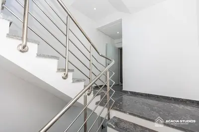 a staircase in a house with stainless steel railings at Acacia Studio 04 in Casablanca