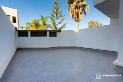a view from the back of a white building with palm trees at Acacia Studio 06 in Casablanca