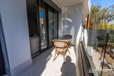 a chair on the balcony of a house at Acacia Studio 07 in Casablanca