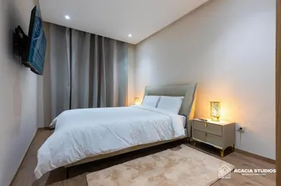 a bedroom with a bed and a tv on a wall at Acacia Studio 11 in Casablanca