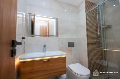 a bathroom with a sink and a toilet and a mirror at Acacia Studio 11 in Casablanca