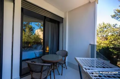a balcony with a table and chairs and a window at Acacia Studio 14 in Casablanca