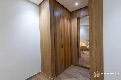a hallway with wood paneling and a glass door at Acacia Studio 15 in Casablanca