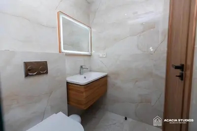a white bathroom with a sink and a mirror at Acacia Studio 15 in Casablanca