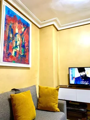 a living room with a couch and a flat screen tv at Top Location Apartment City Center 1min Away From Tram Station in Casablanca