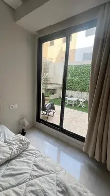 a bedroom with a bed and a large window at home garden in Casablanca