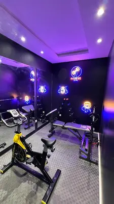 a gym with exercise bikes in a room with purple lighting at N28 3 Bedrooms & Private Gym just walking to Stade Moulay Abdellah in Rabat