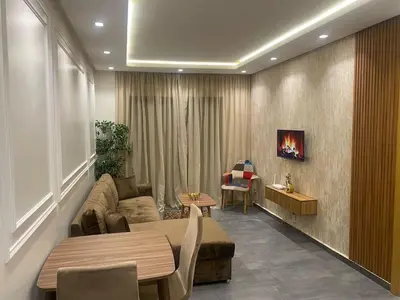 a living room with a couch and a tv on a wall at Downtown delight studio in Casablanca