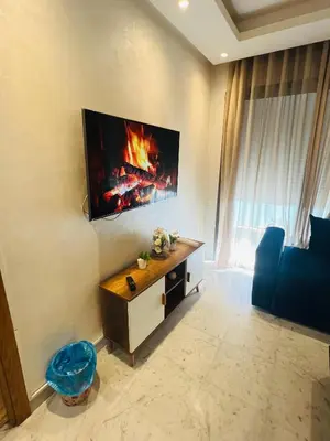 a living room with a fire on the wall at Ataraxia in Casablanca