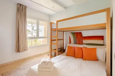a bedroom with a bunk bed with towels on it at Appartement de Luxe - Piscine et Accès à la Plage in Bouznika