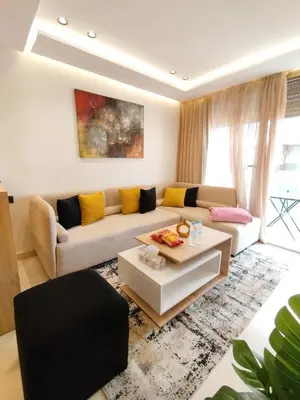 a living room with a couch and a coffee table at Residence La Reine II 24H Reception Cosy & Central Apartment 1 Minute Near To MOHAMMED V SPORTS COMPLEX 5 Min By Car To Ain Diab Corniche With Optical Fiber Wifi Casablanca in Casablanca