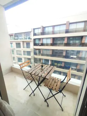 two chairs and a table on top of a building at Residence La Reine II 24H Reception Cosy & Central Apartment 1 Minute Near To MOHAMMED V SPORTS COMPLEX 5 Min By Car To Ain Diab Corniche With Optical Fiber Wifi Casablanca in Casablanca