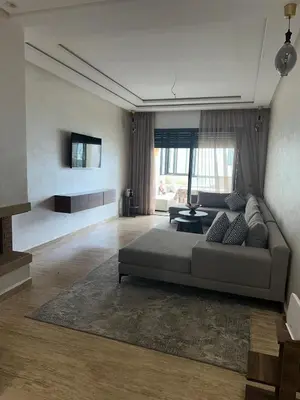 a living room with a couch and a table at Appartement Les Crêtes in Casablanca