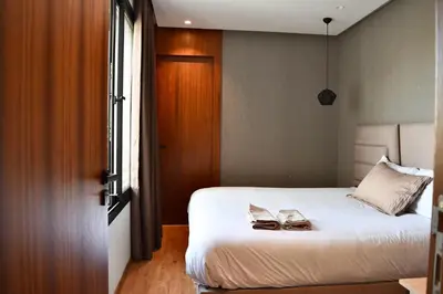 a bedroom with a bed with two shoes on it at Le Palmier - By Mi-Haven in Casablanca