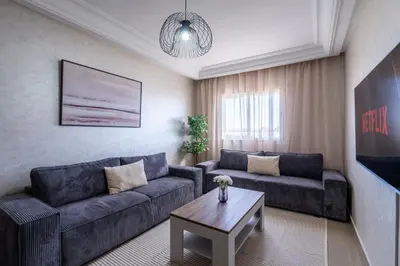 a living room with two couches and a coffee table at Appartement Premium avec Piscine in Mohammedia