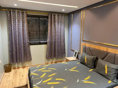 a bedroom with a bed and a window at Studio de la perle in Casablanca