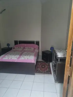 a bedroom with a bed and a table in it at Bayt El Fath in Casablanca
