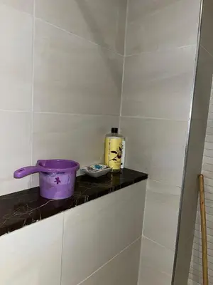 a purple bowl on a shelf in a bathroom at Studio proche clinique akdital ain sebaa in Casablanca