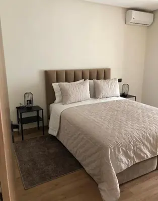 a bedroom with a large bed with white sheets and pillows at Badji in Casablanca