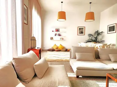 a living room with two white couches and a bed at The 31 Grand Théâtre by IB Signature - Boho Chic 1BR Apt - with Wifi - Self check-in - 24 x7 Security - City View with terrace - Walk to Cafes! City Centre, Tram in Casablanca