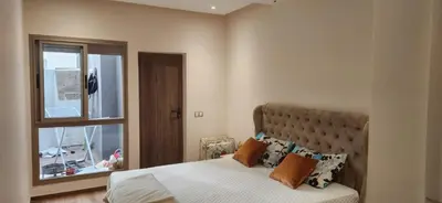 a bedroom with a large bed and a window at le joyau de Parc Group A imm B in Mohammedia