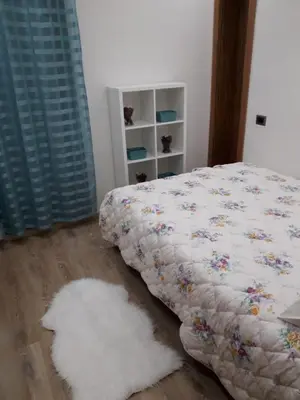 a bedroom with a bed and two white rugs at Appartement sur bd la corniche luxury house with garden close to beach in Casablanca